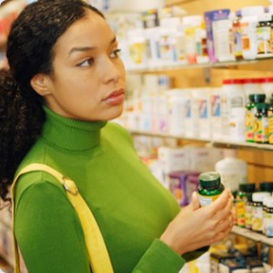 Vitamin C for skin - woman shopping for vitamins