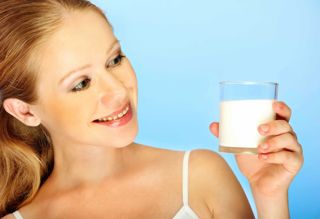 woman with glass of milk skincare