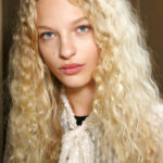 Blonde Unstyled Curls Curly Hair on Blonde Model with cream tied top