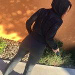 Redhead woman in Prana charcoal hoodie and grey yoga pants