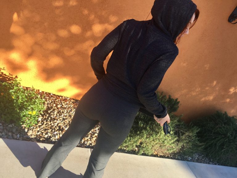Redhead woman in Prana charcoal hoodie and grey yoga pants