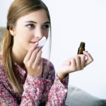 Blonde woman-smelling-essential-oils