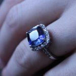 Beautiful dark purple gemstone ring with pave halo
