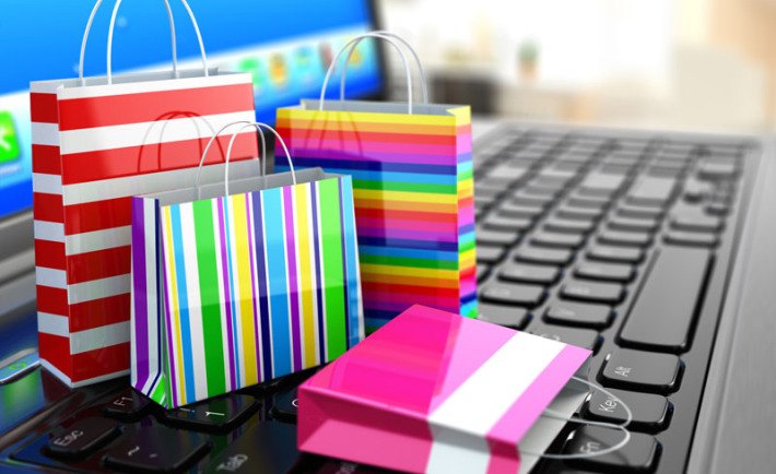 E-commerce. Online internet shopping. Laptop and shopping bags. 3d