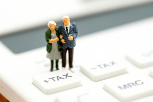 Older couple figure doing taxes