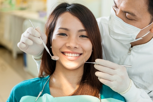 Young woman getting dental exam myths about oral health