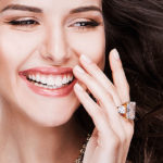 Buying Diamond Jewelry fancy brunette woman blinged out long earrings