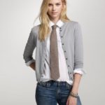 Blonde woman in tie with grey cardigan