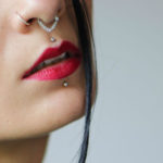 Millennial with nose piercing woman girl red lip