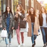 Women walking in the city in winter with dog peacoat leather jacket animal print