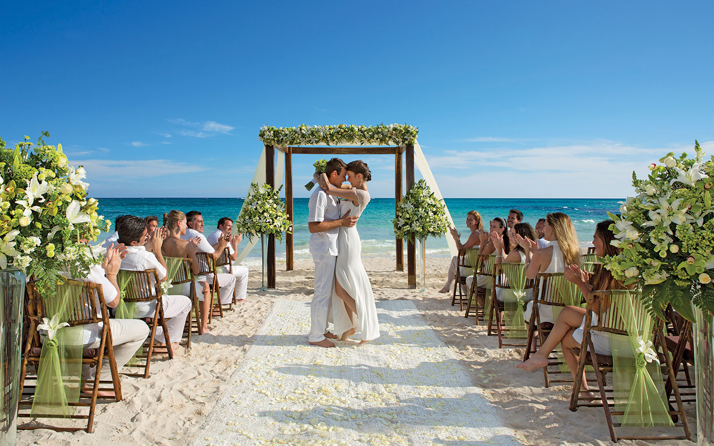 Destination wedding trellis beach bride groom white