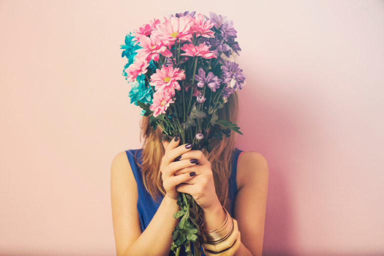 Young beautiful woman smelling flowers bouquet