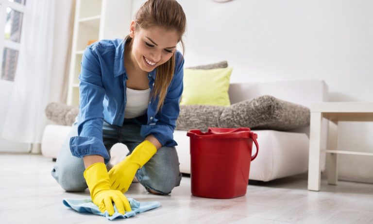 Young woman cleaning floor house bucket