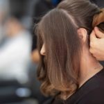 woman getting her hair updo done salon curlers rollers wedding