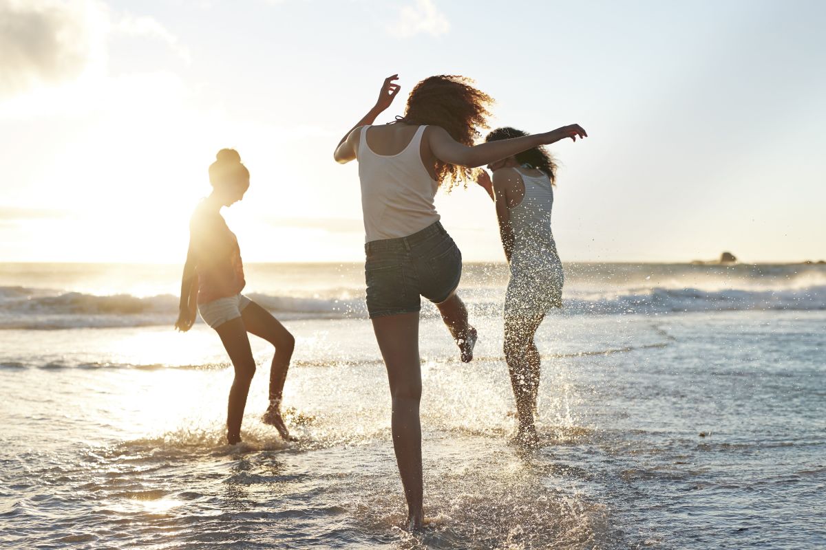 young women playing on california beach