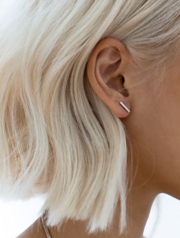 millennial woman waering simple silver bar earrings