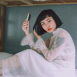 asian woman wooden hairbrush bob haircut