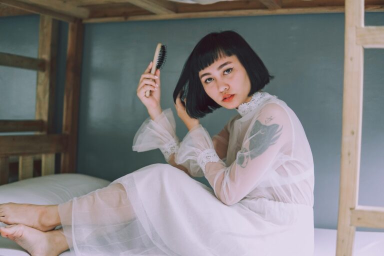 asian woman wooden hairbrush bob haircut