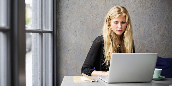 blonde woman using internet laptop