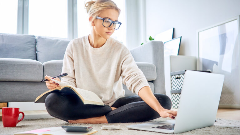 smart gen z girl on floor with laptop