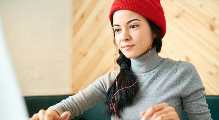 woman in red beanie with headphones turtleneck