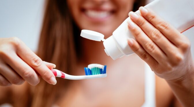 woman toothpaste toothbrush