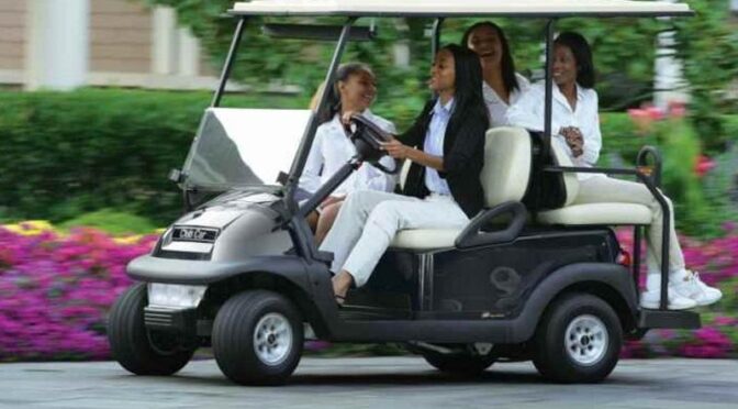 Black women in golf cart