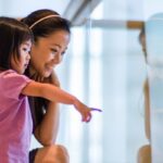 Toddler girl and young mom in shopping mall
