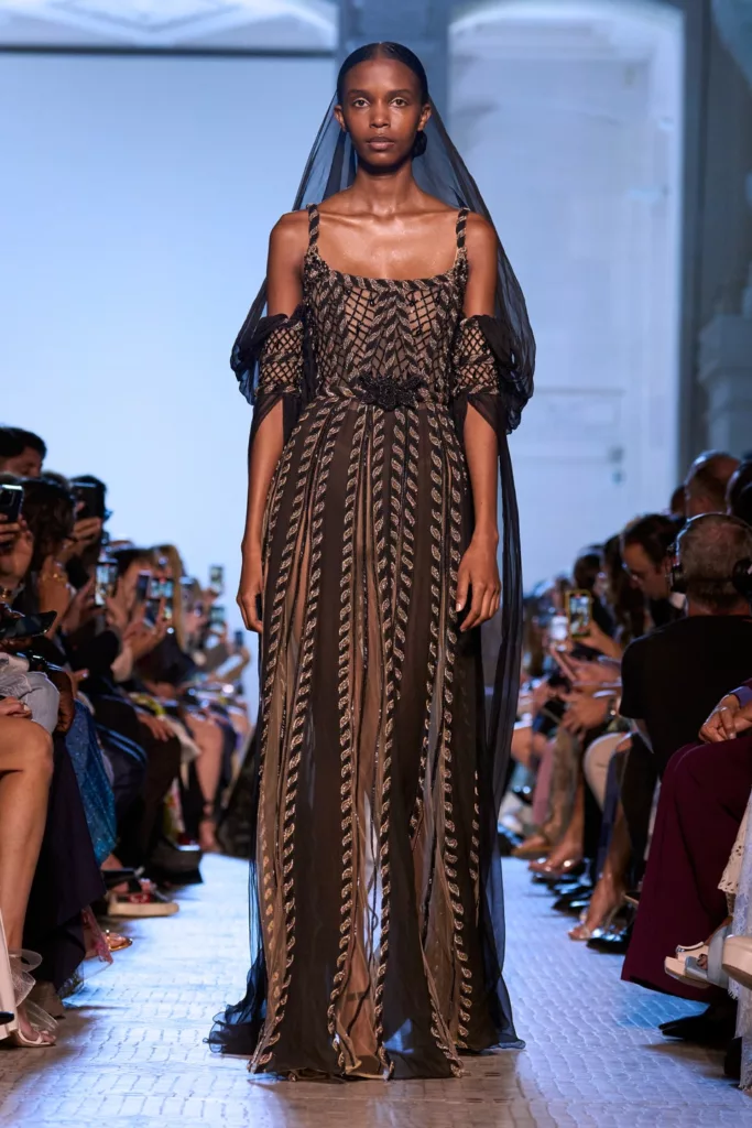 Model in Veil & Black Patterned Off Shoulder Gown